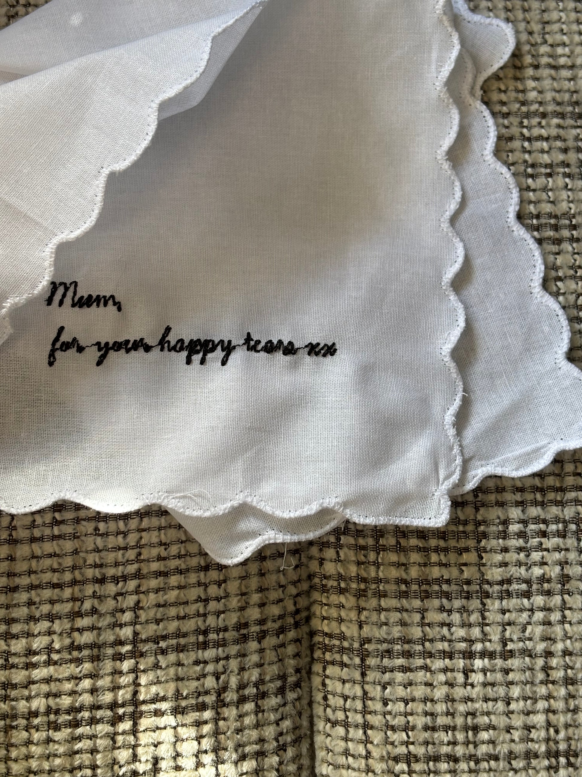 White fabric with text on a textured beige surface