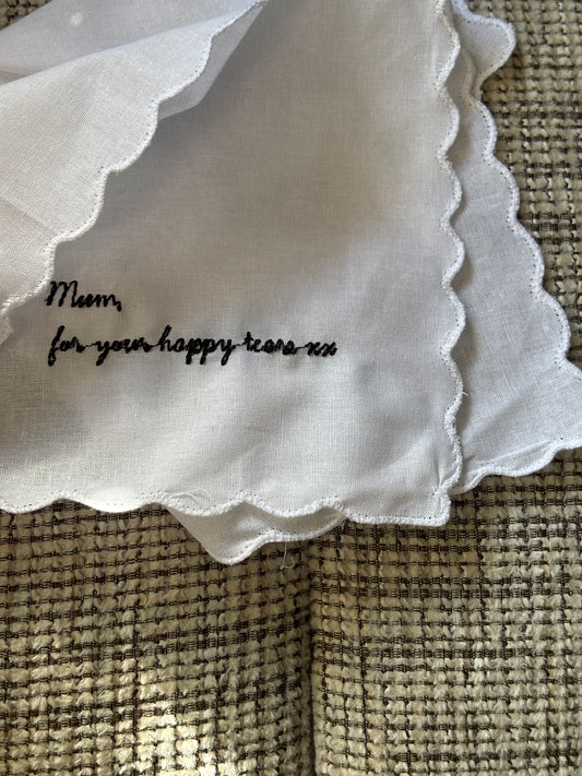 White fabric with text on a textured beige surface